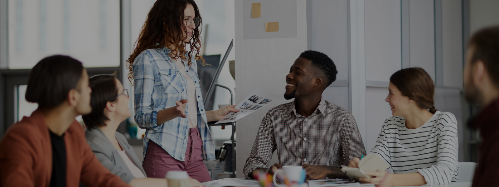 Group of employees casually collaborating during meeting